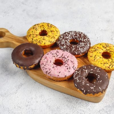 Assorted donuts with chocolate frosted, pink glazed and sprinkle